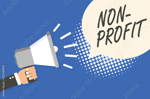Conceptual hand writing showing Non Profit. Business photo text providing products or service without paying back in return Man holding megaphone loudspeaker speech bubble blue background © Artur