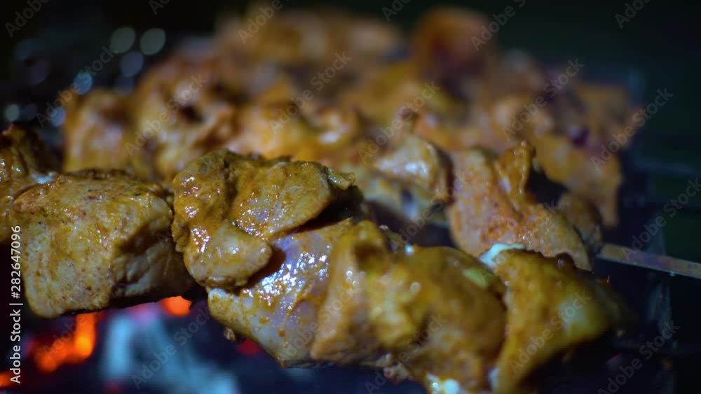 Shish kebab. Pork or lamb meat pieces being fried on a charcoal grill. Frying grilled pieces of meat during the rest. Shish kebab. Pork or lamb meat pieces being fried on a charcoal grill. Frying grilled pieces of meat during the rest.
