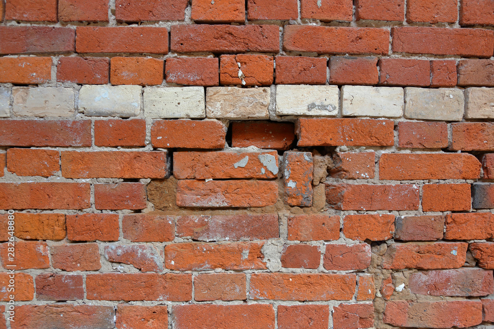 Embossed textured surface of the old orange brick and cement wall Embossed textured surface of the old orange brick and cement wall