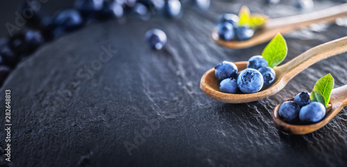 Juicy and Fresh Blueberries with Green Leaves. Concept for Healthy Eating
