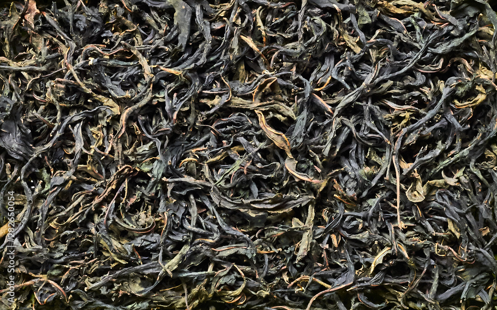 Handmade green tea made of fermented blooming sally herb, background texture, flat lay, overhead top view from above, closeup Handmade green tea made of fermented blooming sally herb, background texture, flat lay, overhead top view from above, closeup