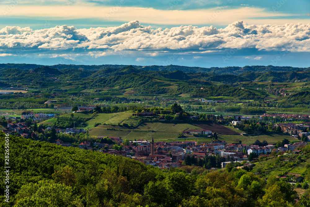 City of Alba heart of the Langhe in Piedmont Italy view from above surrounded by hills full of vineyards and woods in the sky suggestive clouds