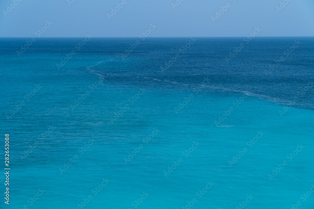 Sea surface. Blue background. Azure sea. Azure and turquoise backgrond. Marine waves.