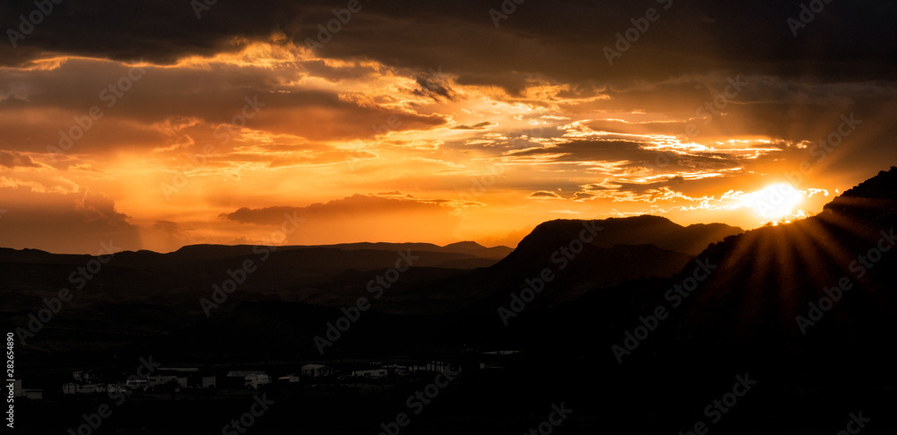 Sunsetting in the mountains over the desert Sunsetting in the mountains over the desert