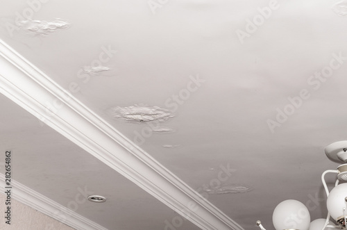 Stains on the ceiling a result of leaking rain water roof. House insurance.