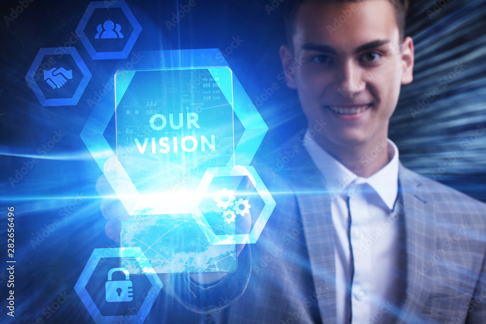 The concept of business, technology, the Internet and the network. A young entrepreneur working on a virtual screen of the future and sees the inscription: Our vision The concept of business, technology, the Internet and the network. A young entrepreneur working on a virtual screen of the future and sees the inscription: Our vision