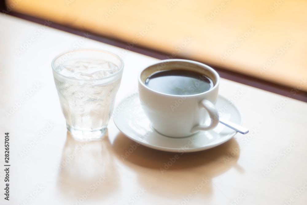 Hot Coffee cup and drink water on the wooden table as beverage background Hot Coffee cup and drink water on the wooden table as beverage background