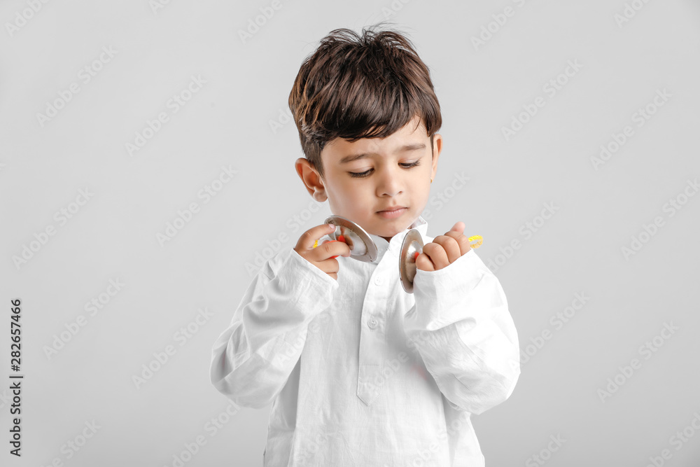 Indian Little Boy in Traditional Dress and learning with Musical instrument Indian Little Boy in Traditional Dress and learning with Musical instrument