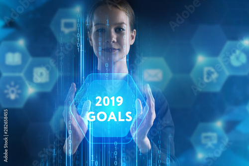 The concept of business, technology, the Internet and the network. A young entrepreneur working on a virtual screen of the future and sees the inscription: 2019 goals