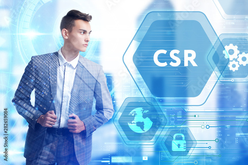 The concept of business  technology  the Internet and the network. A young entrepreneur working on a virtual screen of the future and sees the inscription  CSR