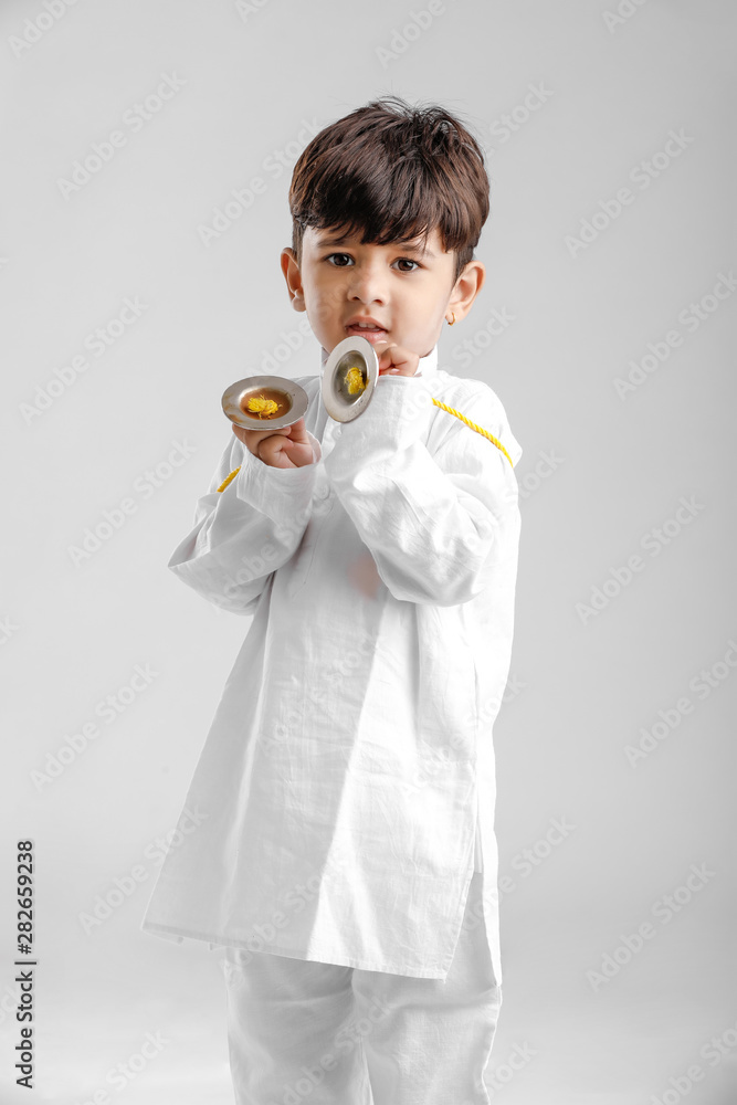 Indian Little Boy in Traditional Dress and learning with Musical instrument Indian Little Boy in Traditional Dress and learning with Musical instrument