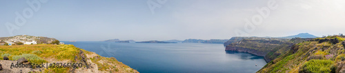 Wide view from the bay near the city of Akrotiri, to the inner coastline of the volcanic Thera archipelago and the Nea Kameni island in the center.