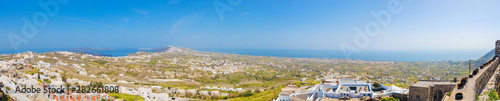 Top north view of the greek Santorini isle, from Pyrgos with aluminium cans for the easter fire festival at the roofs and on the wall of the castle.