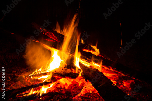 fire of wooden boards lit at night for the whole frame