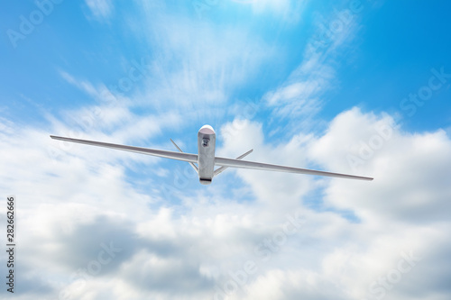 Unmanned military drone flies patrolling the territory the at day clouds sky.