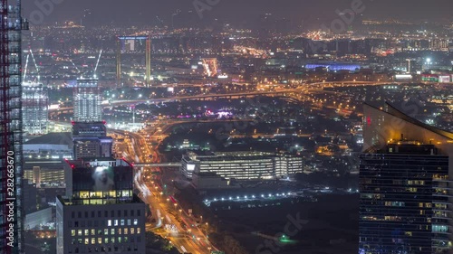 Wallpaper Mural Aerial view to financial and zabeel district night timelapse with traffic and under construction building with cranes from downtown Dubai. Deira on a background. Illuminated skyscrapers Torontodigital.ca