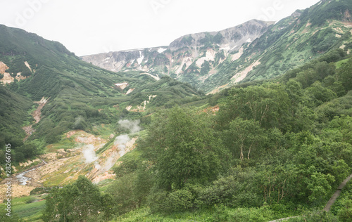 Valley of Geysers in Kronotsky Nature Reserve. A geyser field on Kamchatka Peninsula, Russia. Slopes around Geysernaya River, into which geothermal waters flow from stratovolcano Kikhpinych.