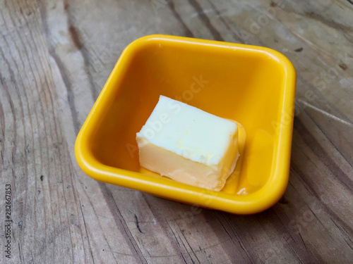 Butter Piece in Yellow Plastic Cup Ready to Use.