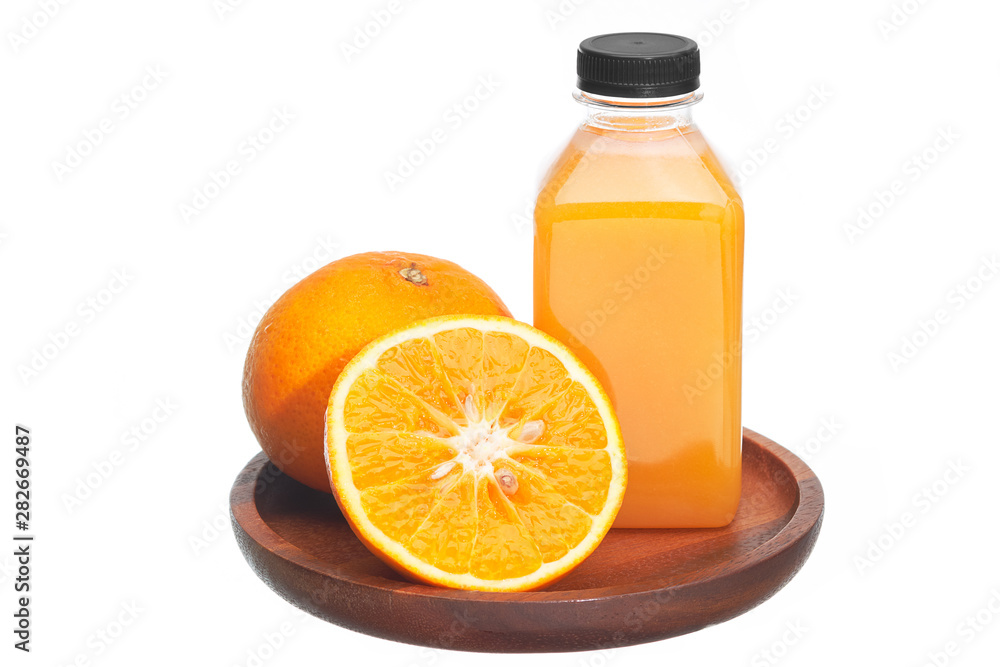 Orange juice in plastic bottles and fruits in wooden plate isolated on white background. Orange juice in plastic bottles and fruits in wooden plate isolated on white background.