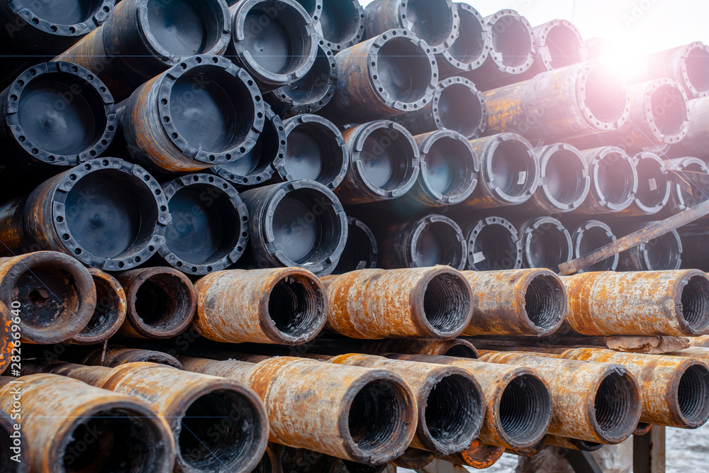Drill pipe of  oil drilling platforms. Stack of oil well casing bundles at the pin end of casing. Downhole drilling rig