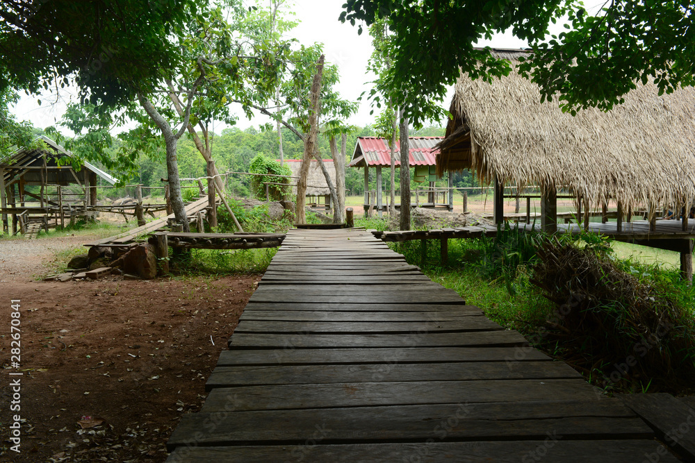 The wooden bridge  connect to the empty huts at the tourist attraction on the dam coast at UdonThani ,Thailand