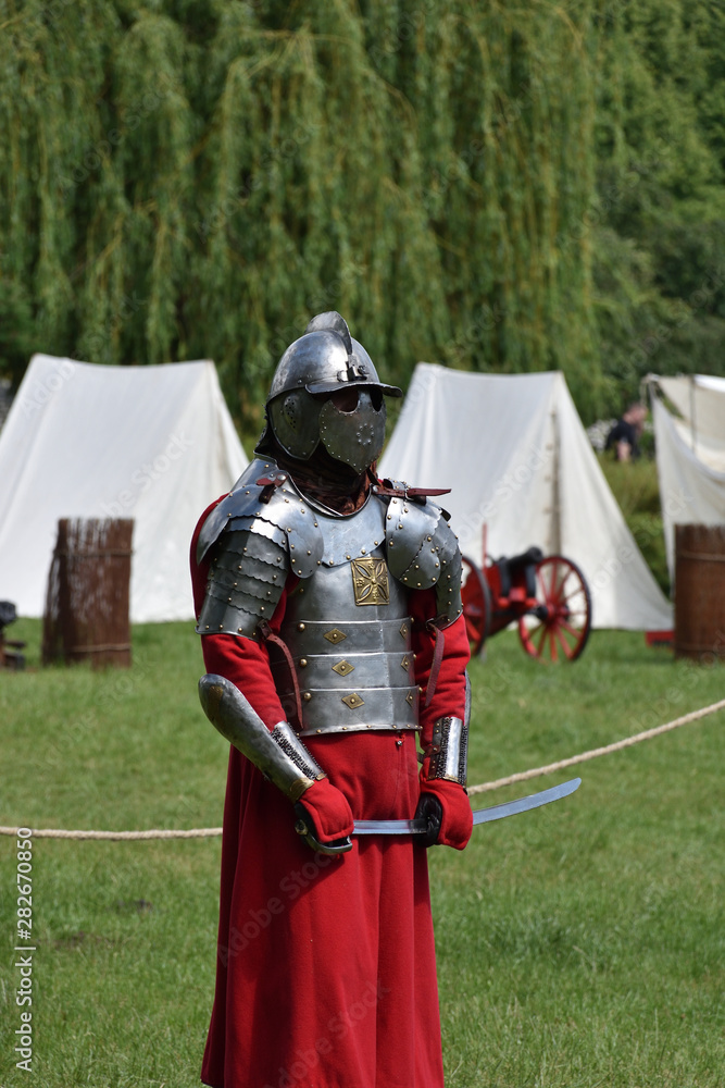 Medieval Polish knight in a cuirass with a sabre preparing to fight