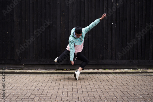 Young man dancing on street photo