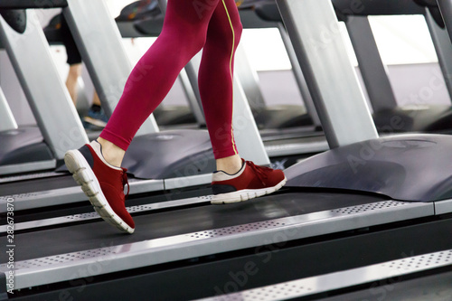 Close up of male legs running on treadmill in gym