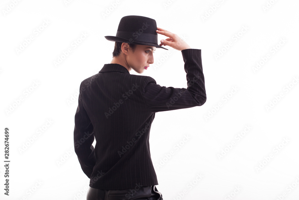 Beautiful fashion model posing in studio over white background with retro hat Beautiful fashion model posing in studio over white background with retro hat