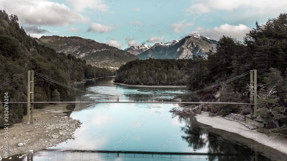 Lake in winter with a person walking in a bridge Lake in winter with a person walking in a bridge