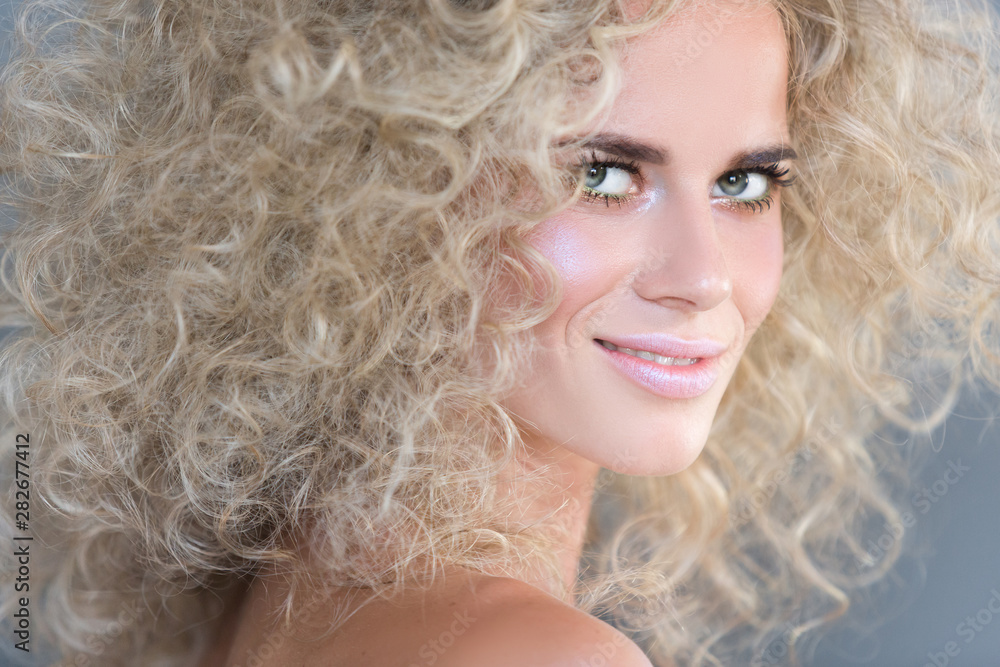Close-up portrait of a positive charming young blue-eyed blonde girl with curly hair and bright pink delicate make-up. Concept of creating a stylish image. Copy space, 16:9 Widescreen Close-up portrait of a positive charming young blue-eyed blonde girl with curly hair and bright pink delicate make-up. Concept of creating a stylish image. Copy space, 16:9 Widescreen