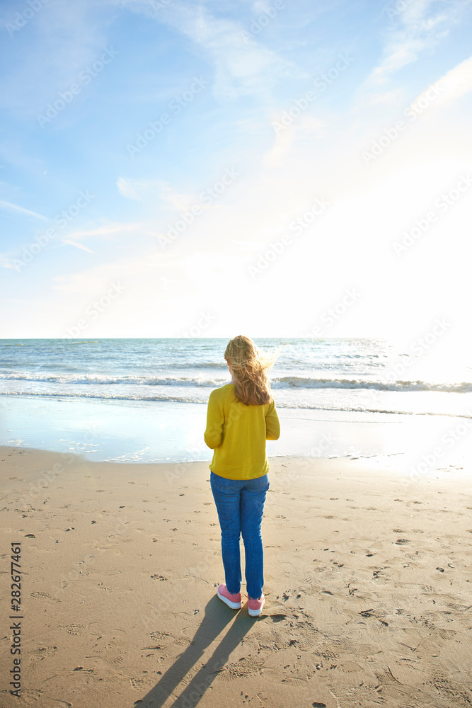 Full length shot of woman standing on the beach