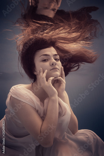 Portrait of a girl in a dress under water