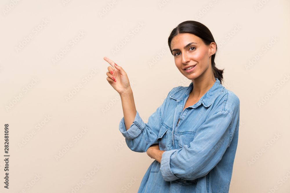Young woman over isolated background pointing finger to the side Young woman over isolated background pointing finger to the side