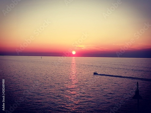 Red sunset with boat © Veer