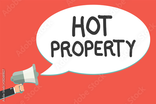 Text sign showing Hot Property. Conceptual photo Something which is sought after or is Heavily Demanded Man holding megaphone loudspeaker speech bubble message speaking loud © Artur