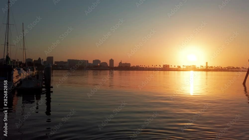 Time lapse of glowing orange sunrise at Long Beach harbor, California Time lapse of glowing orange sunrise at Long Beach harbor, California