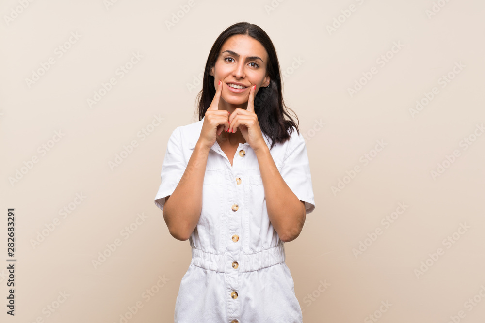 Young woman over isolated background smiling with a happy and pleasant expression Young woman over isolated background smiling with a happy and pleasant expression