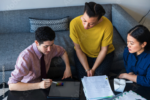 Three coworkers looking at paperwork