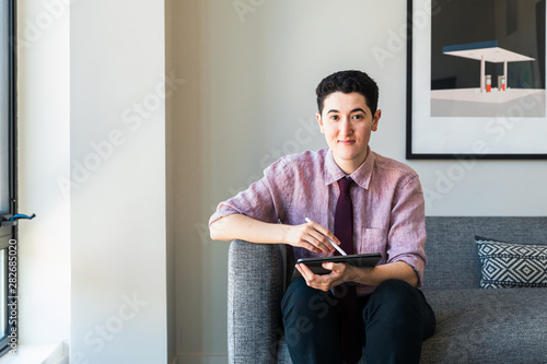 Portrait of businessman holding tablet