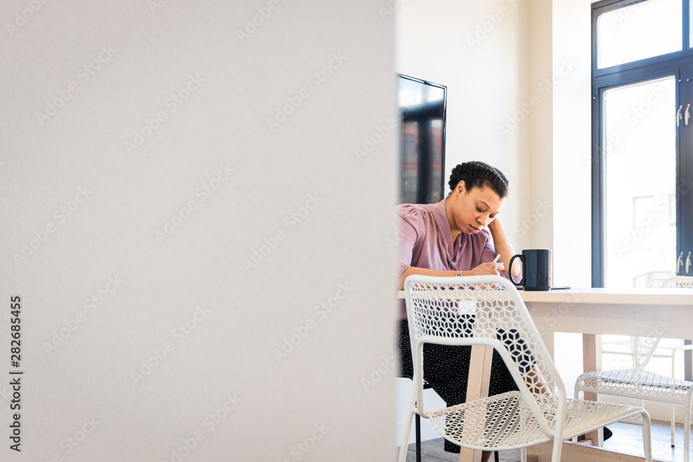 Thoughtful businesswoman looking at tablet Thoughtful businesswoman looking at tablet
