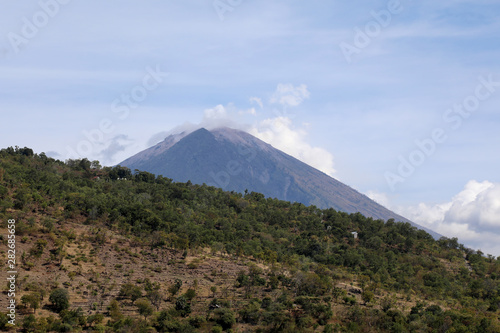 Amed, Indonesia – July 3 2018: View of the smoking volcano of Mount Agung in east Bali, Indonesia