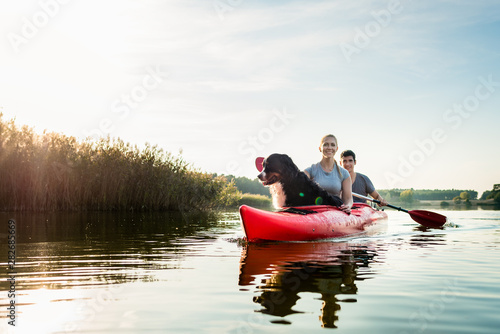 Dog and woman sitting with a man kayaking
