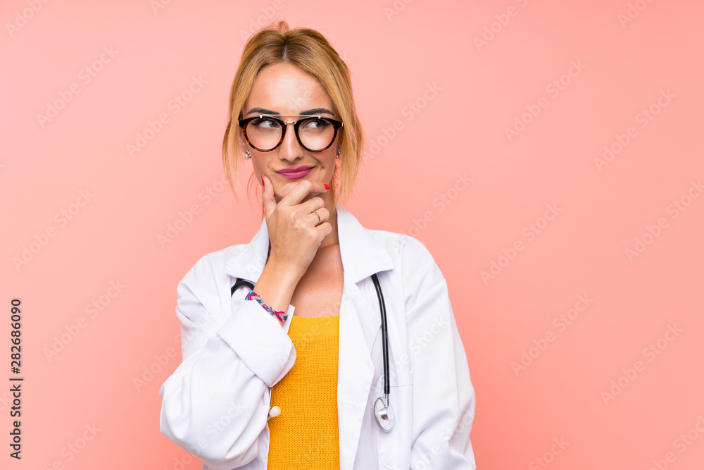 Young blonde doctor woman thinking an idea Young blonde doctor woman thinking an idea