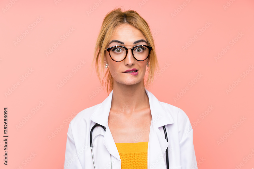 Young blonde doctor woman having doubts and with confuse face expression Young blonde doctor woman having doubts and with confuse face expression