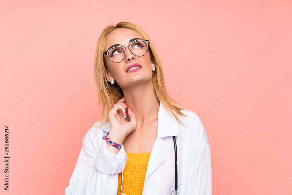Young blonde doctor woman thinking an idea Young blonde doctor woman thinking an idea