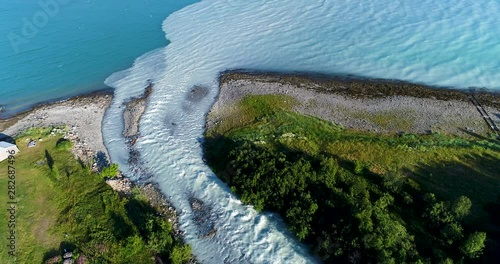 Aerial view of glacial river meeting the sea in national park in Norway