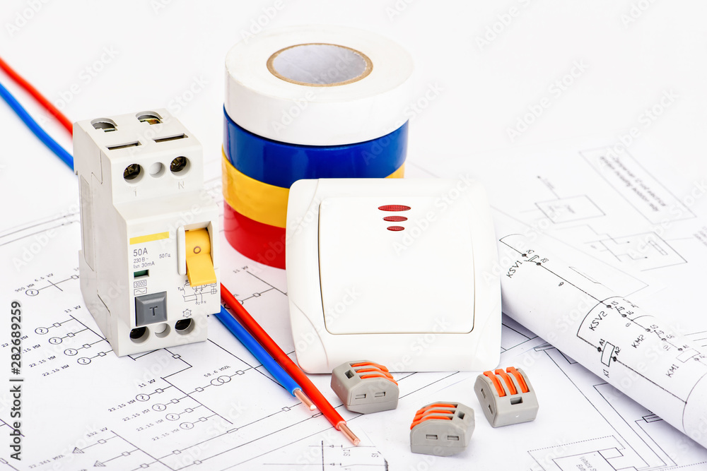 Fototapeta premium Automatic circuit breakers, copper single core cable. Accessories for safe and secure electrical installation. Electrical equipment, protection and control, white background.