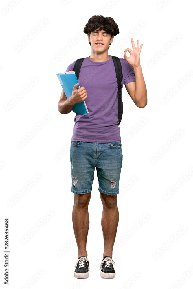 A full-length shot of a Young student man in zen pose over isolated white background