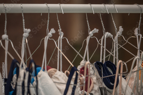 a hanger with clothes, iron shoulders hang on a clothesline,